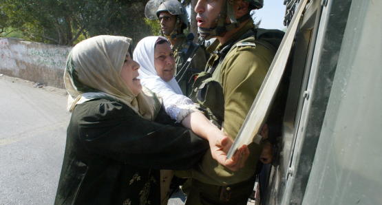 Emad's mother pleads with an Israeli soldier to release her son Khaled after he was arrested.