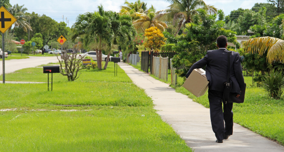 Byrd (Andre Royo) walking down the sidewalk with the Steel water filters.